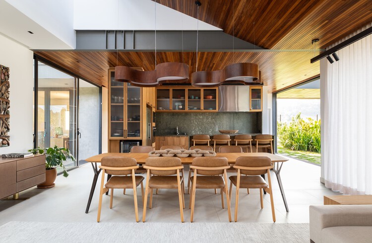 Entreverdes House / 24 7 Arquitetura - Интерьерная фотография, столовая, дерево, стол, стул, освещение